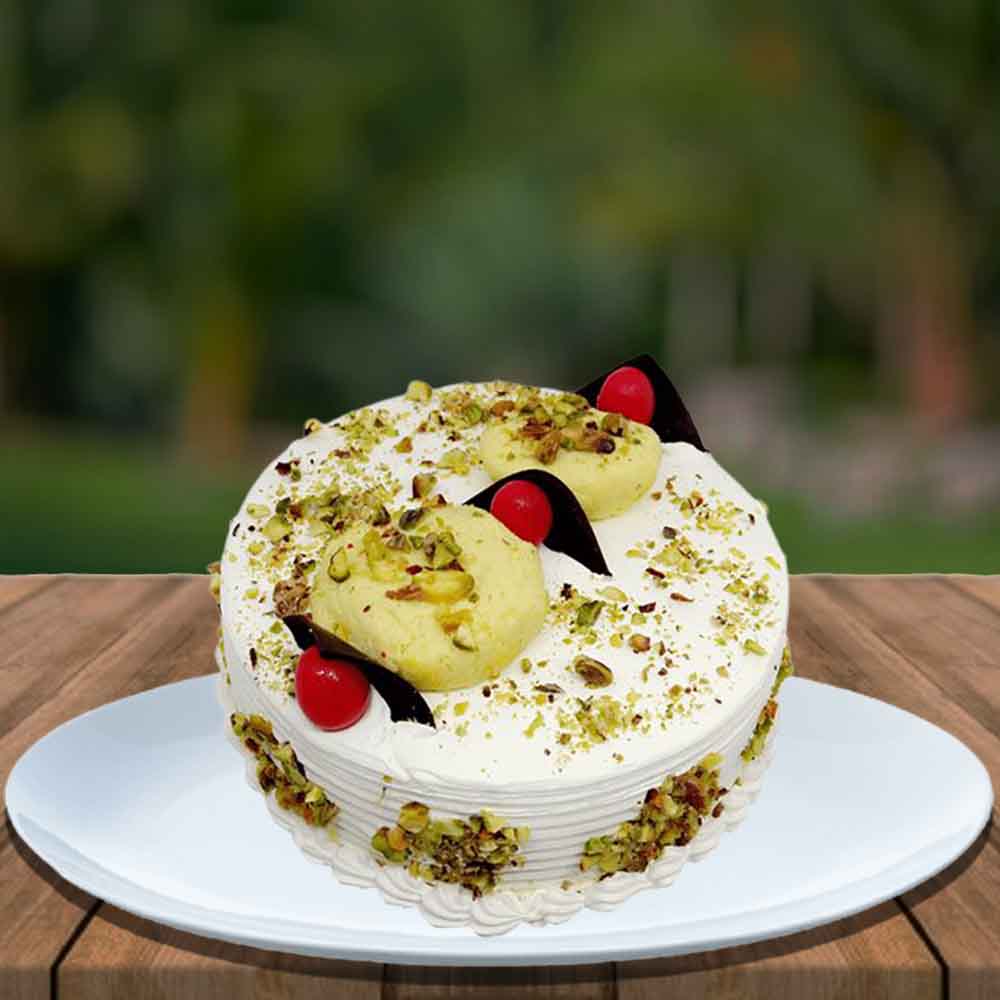 Rasmalai cake with garnish cherry and pista
