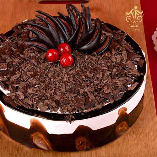 Round black forest cake with  cherries