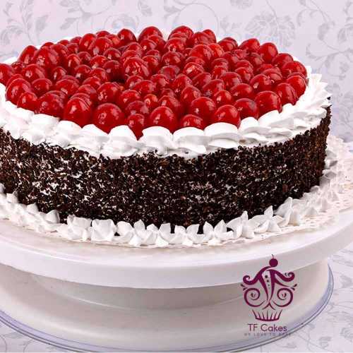 Round black forest cake full of cherry toppings