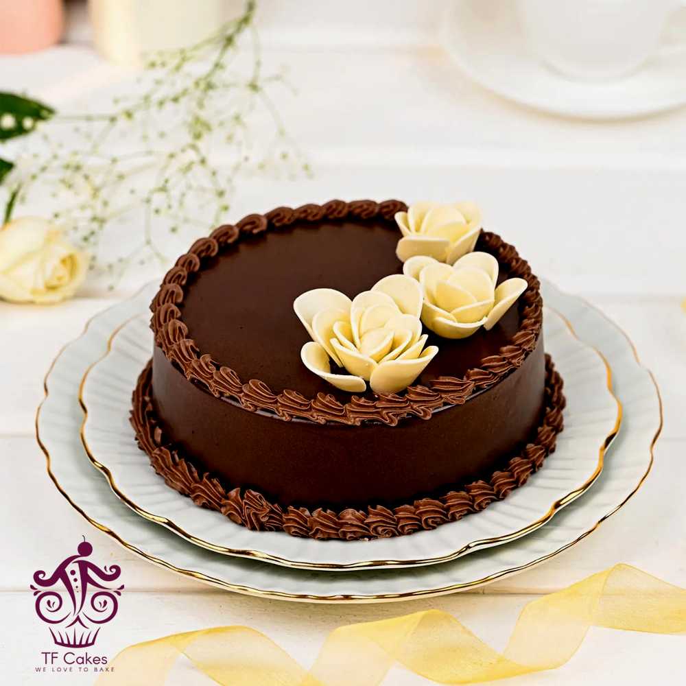 Chocolate cake  with three gorgeous white flowers